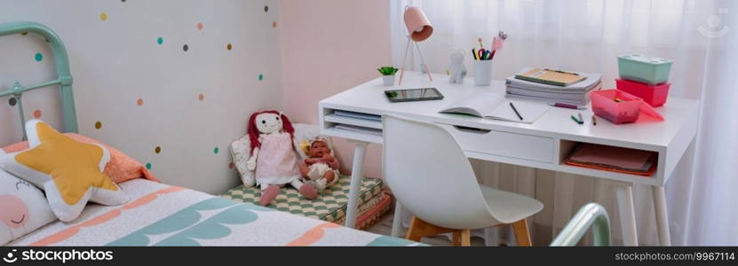 Girl’s bedroom with bed and desk decorated in pastel colors