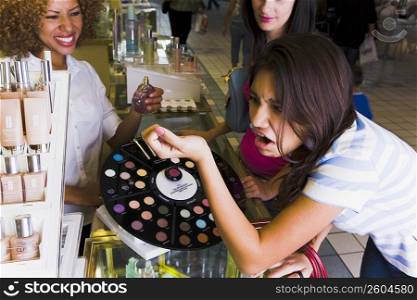 Girl sampling perfume and not liking the scent