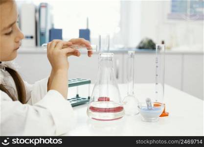 girl scientist laboratory with test tubes experimenting