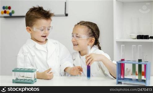 girl scientists doing experiments laboratory having fun