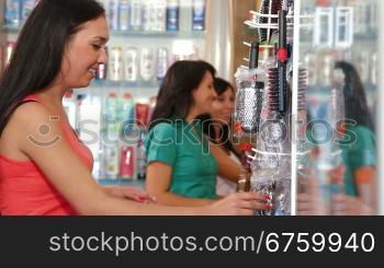 Girl Shopping in Cosmetics Store, Choosing Hairbrush