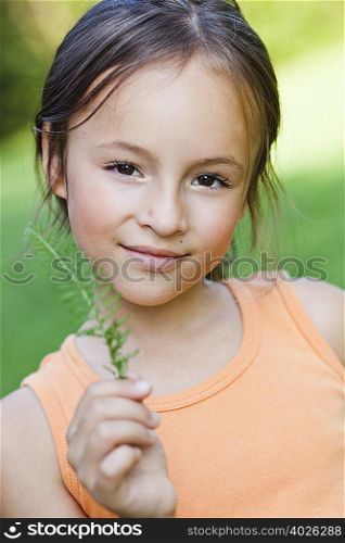 girl showing plant to viewer