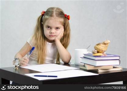 girl sits at a table and wrote on a sheet of paper. There are tombs of books, sheets of paper, a pen, glass globe, with a glass of tea, sea shell. The image of the writer