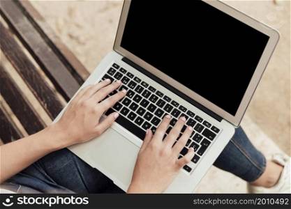 girl sitting bench with laptop