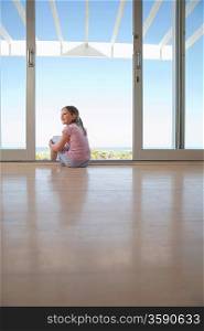 Girl Sitting By Glass Doors