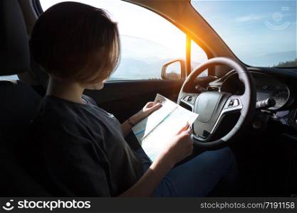 girl sitting in the car and looking map