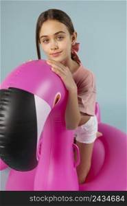 girl sitting inflatable flamingo