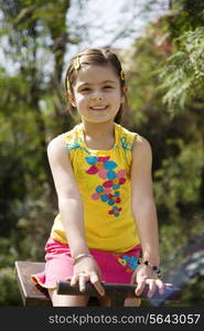 Girl sitting on a see-saw