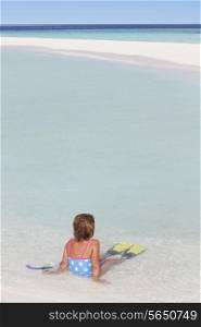 Girl Sitting On Beach Wearing Snorkel And Flippers