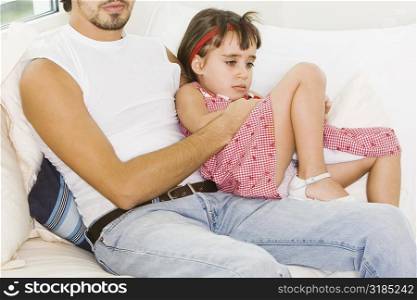 Girl sitting on her father&acute;s lap