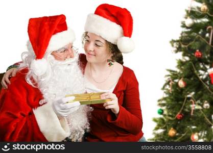 Girl sitting on Santa Claus&rsquo; lap, getting a Christmas present from him. Isolated on white.