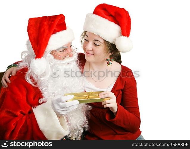 Girl sitting on Santa Claus&rsquo; lap, getting a Christmas present from him. Isolated on white.
