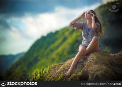 Girl Sitting on the Beach Wearing Sunglasses