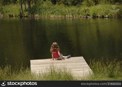 Girl sitting on the dock