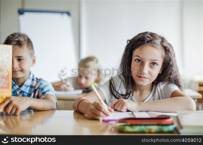girl sitting table writing