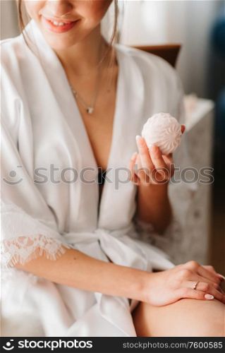 girl sitting with marshmallows in light clothes