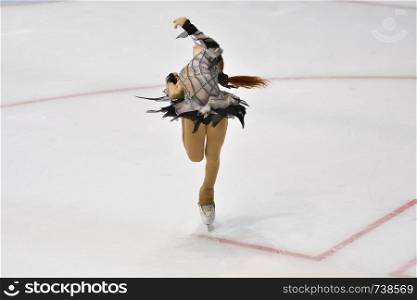 Girl skater skates on ice sports arena