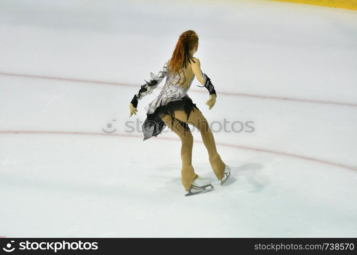 Girl skater skates on ice sports arena