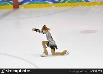 Girl skater skates on ice sports arena