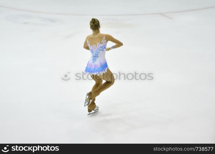 Girl skater skates on ice sports arena