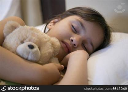 Girl sleeping with a stuffed toy