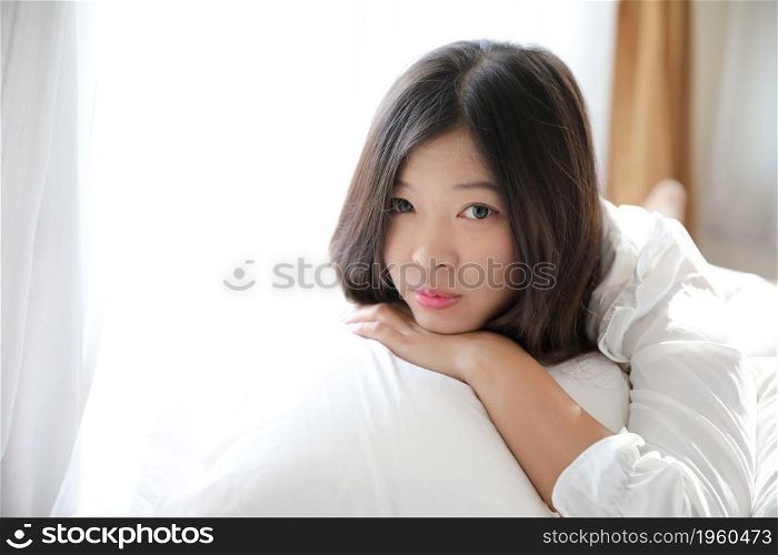 girl sleeping with pillow at white bedroom