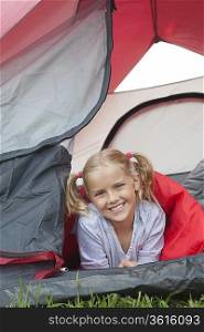 Girl smiles from tent