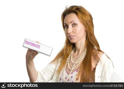 Girl smiles with packing of toothpaste