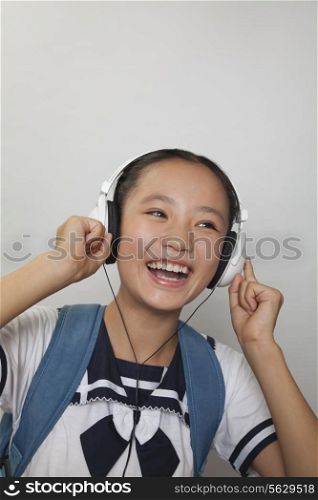 Girl smiling and listening to music, Studio