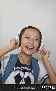Girl smiling and listening to music, Studio