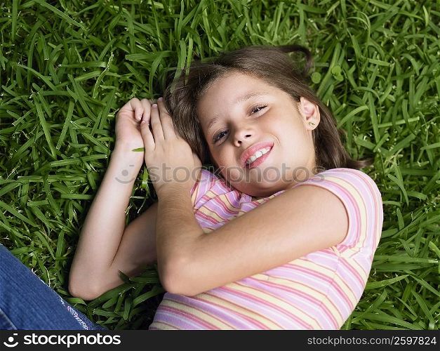 Girl smiling and lying on the grass
