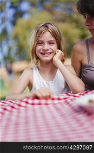 Girl smiling at picnic table