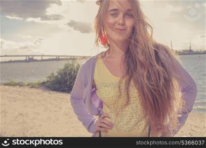 Girl smiling. Beautiful girl in the morning on the beach. Colorized shot. Retro looking image.
