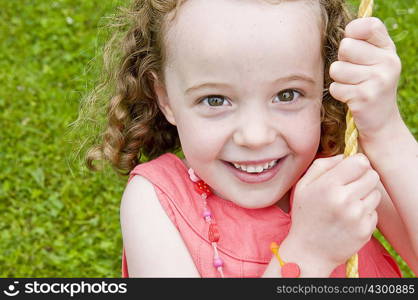 Girl smiling on swing