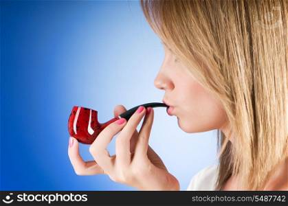 Girl smoking pipe against the gradient background