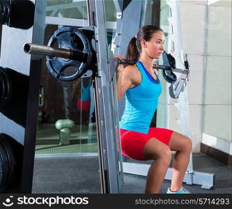 girl squats in multipower squatting smith machine barbell at gym smith