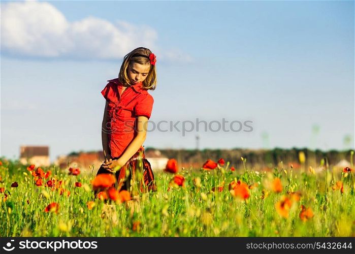 Girl stand with arms outstretched in the poppies field and enjoy the nature