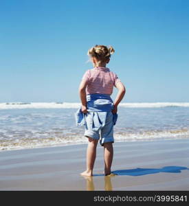 Girl standing by the sea