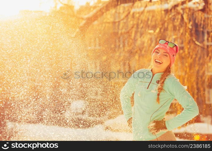 Girl standing in snow. Young woman having fun in winter park. Health nature relax fashion fitness concept. . Girl standing in snow