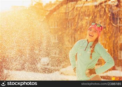 Girl standing in snow. Young woman having fun in winter park. Health nature relax fashion fitness concept. . Girl standing in snow