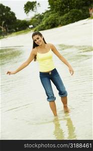Girl standing in water on the beach