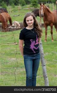 Girl standing near a ranch, Northern Alberta, Alberta, Canada