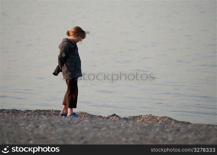 Girl standing on the beach at Gimli, Manitoba, Canada
