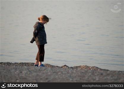 Girl standing on the beach at Gimli, Manitoba, Canada