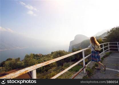 girl standing on the viewing platform and look at the lake Garda. Italy