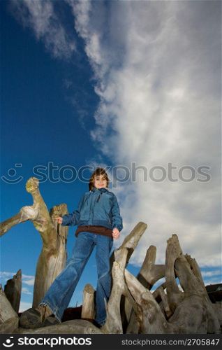 Girl standing on wooden logs, portrait
