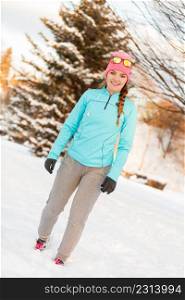 Girl staying fit during winter, exercising in winter park. Fitness health fashion concept. Girl staying fit during winter