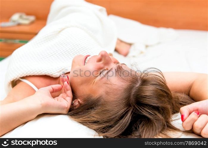 girl stretches awake in bed in the morning