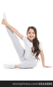 Girl stretching leg. Small girl doing stretching leg exercise isolated on white background