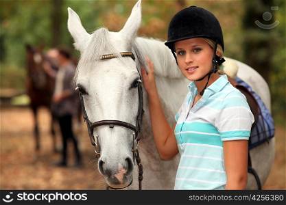 Girl stroking white horse